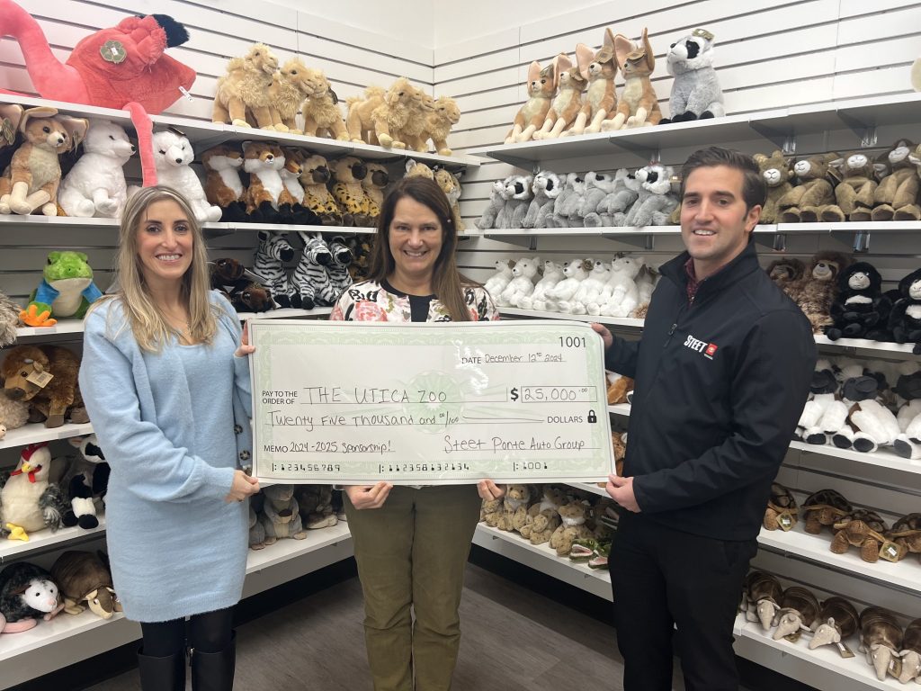 Carly Steet Mathias, left, Andria Heath, Utica Zoo Director, middle, and Joe Steet Jr., right, presenting the $25,000 donation to the Utica Zoo!