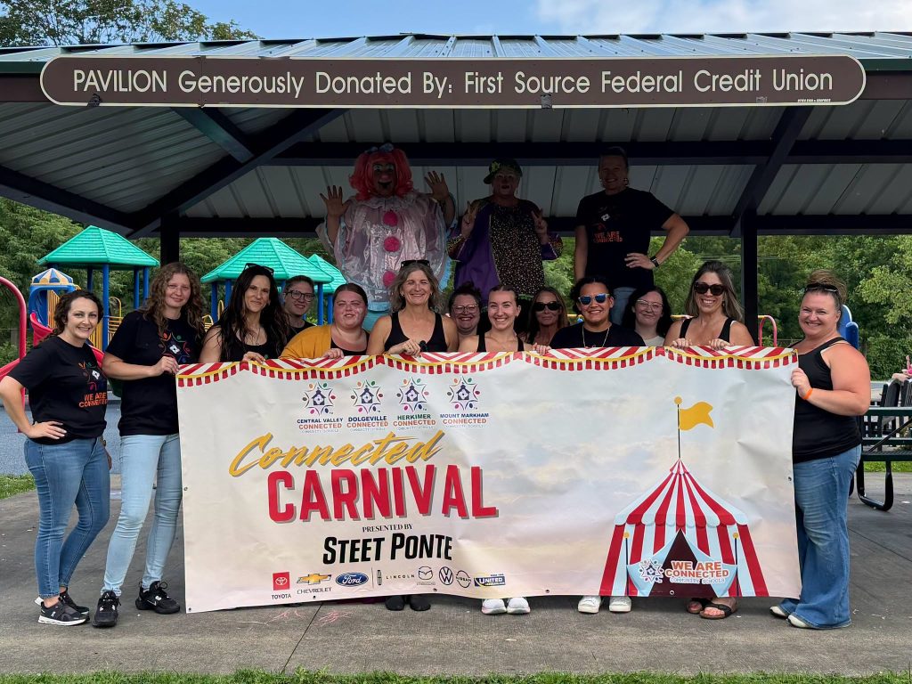 Connected Community Schools Team with Carnival Banner
