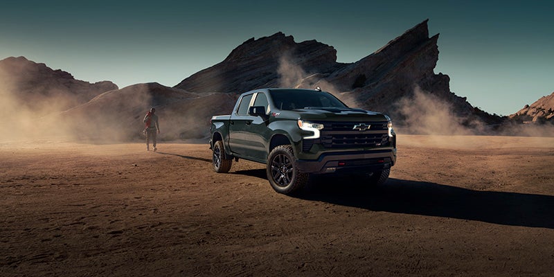 the 2025 Chevrolet Silverado 1500 driving down a dirt road in the desert