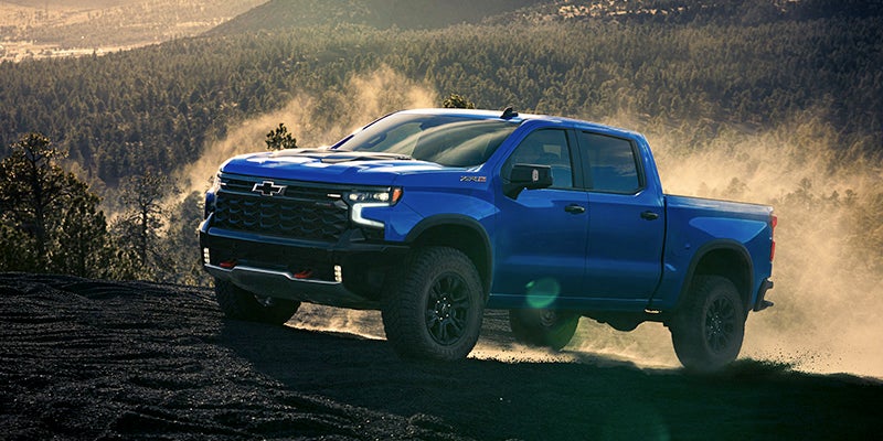 the 2025 Chevrolet Silverado 1500 off-roading in the mountains